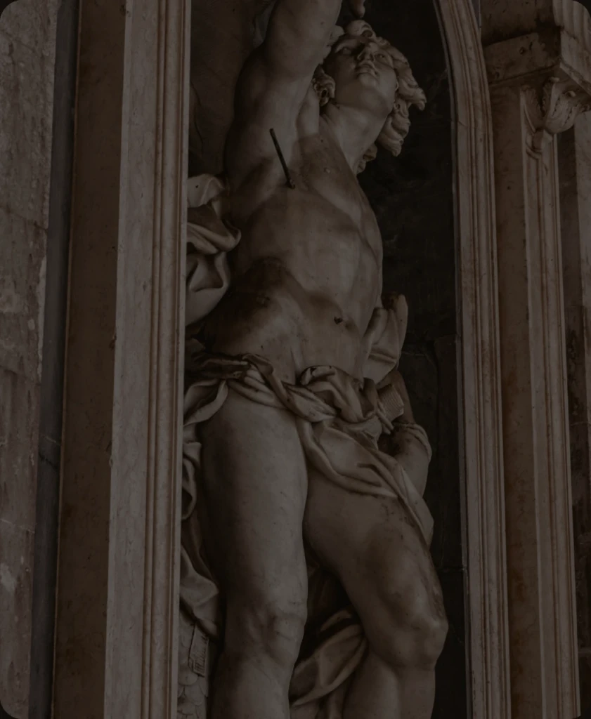 Classical marble statue in a carved stone niche